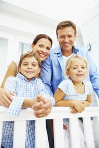Portrait of happy mature parents with little kids
